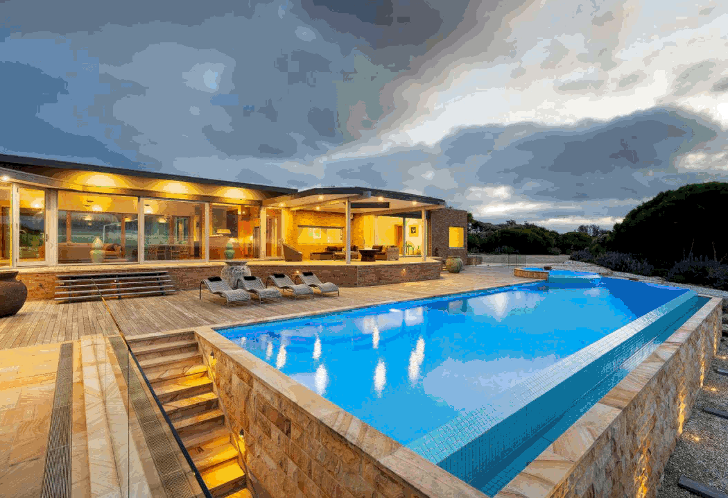 A slideshow of images of a home near the beach showing rooms and entertainment options